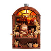 A wooden book nook display with LED lighting featuring small potted plants and decorative items.