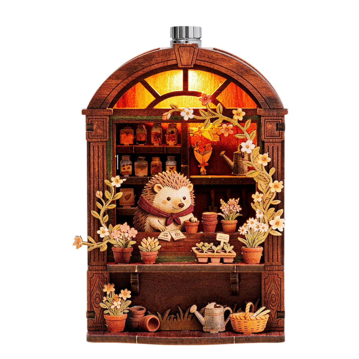 A wooden book nook display with LED lighting featuring small potted plants and decorative items.