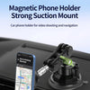 A magnetic phone holder is mounted on a car dashboard, used for video shooting and navigation.
