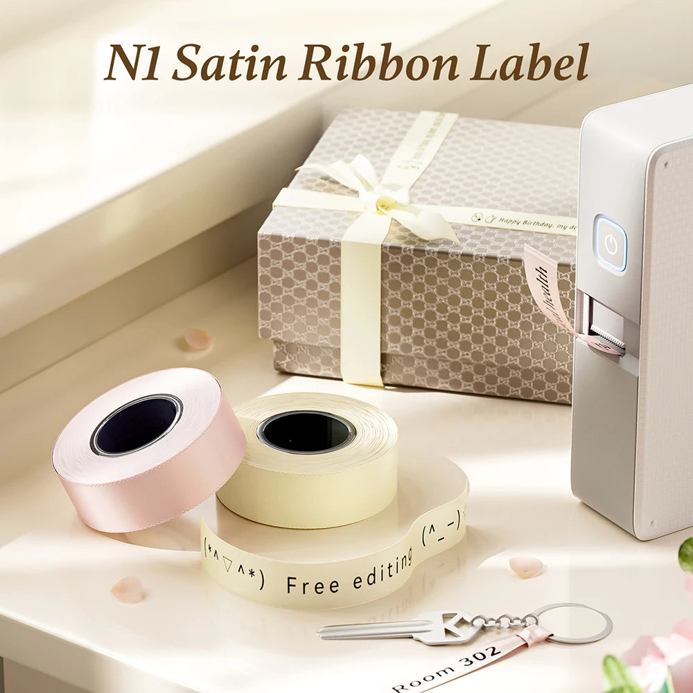 Rolls of satin ribbon labels for an N1 label printer displayed on a white surface.