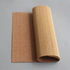 A roll of hand-woven bamboo tea mat showing its texture and natural tan color.