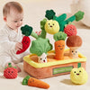 A baby is interacting with a colorful vegetable farm toy featuring carrot and mushroom shapes for fine motor skill developmen