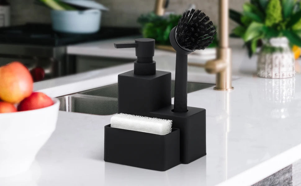 A black kitchen soap dispenser with a sponge holder and brush resting on a white countertop.