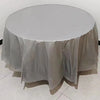 A round table covered with a white or light gray disposable tablecloth, set up for an event.