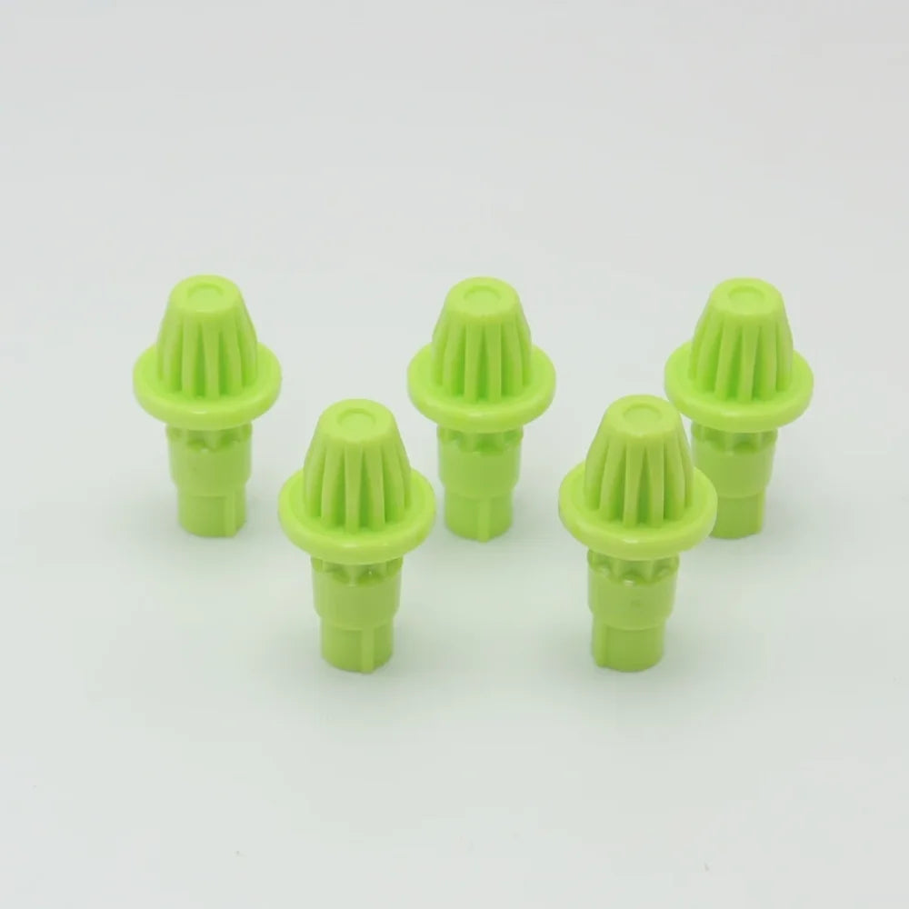A set of five bright lime green replacement drivers for a Battling Top, packaged together.