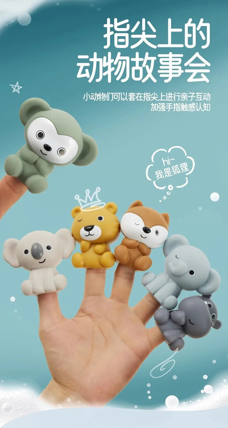 A hand holds several soft silicone animal toys floating on water, demonstrating a sensory play set for toddlers.