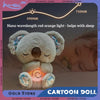 A fluffy cartoon koala plush toy with an orange glowing light is shown resting on a person's face for sleep.