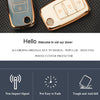 A pair of gold-colored TPU silicone key cases for car, VW, Skoda, and Seat flip keys shown on a dark surface.