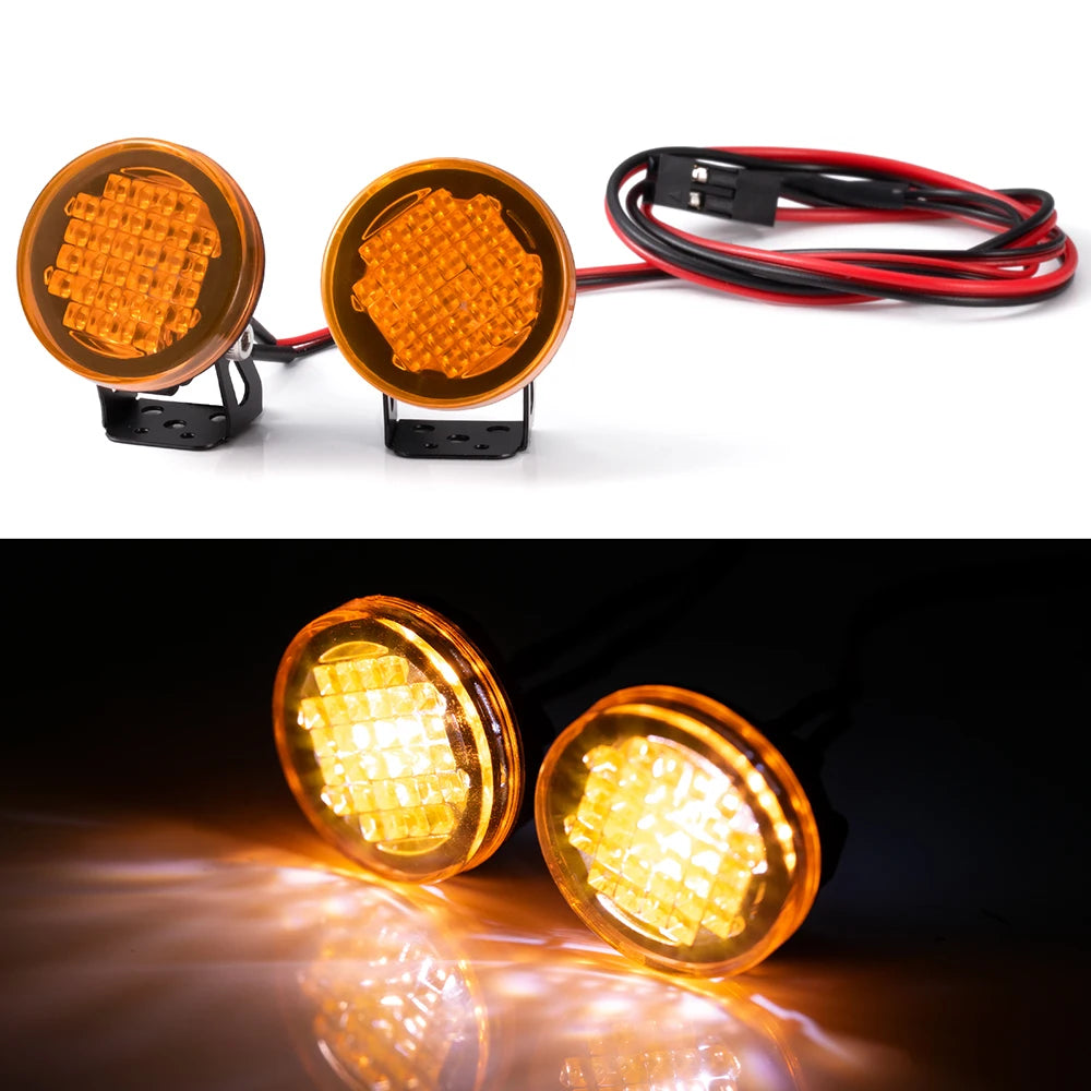 Two orange LED headlight and spotlight units with attached wiring for RC crawler trucks