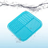 A bright blue silicone lick mat for pets floating in water.