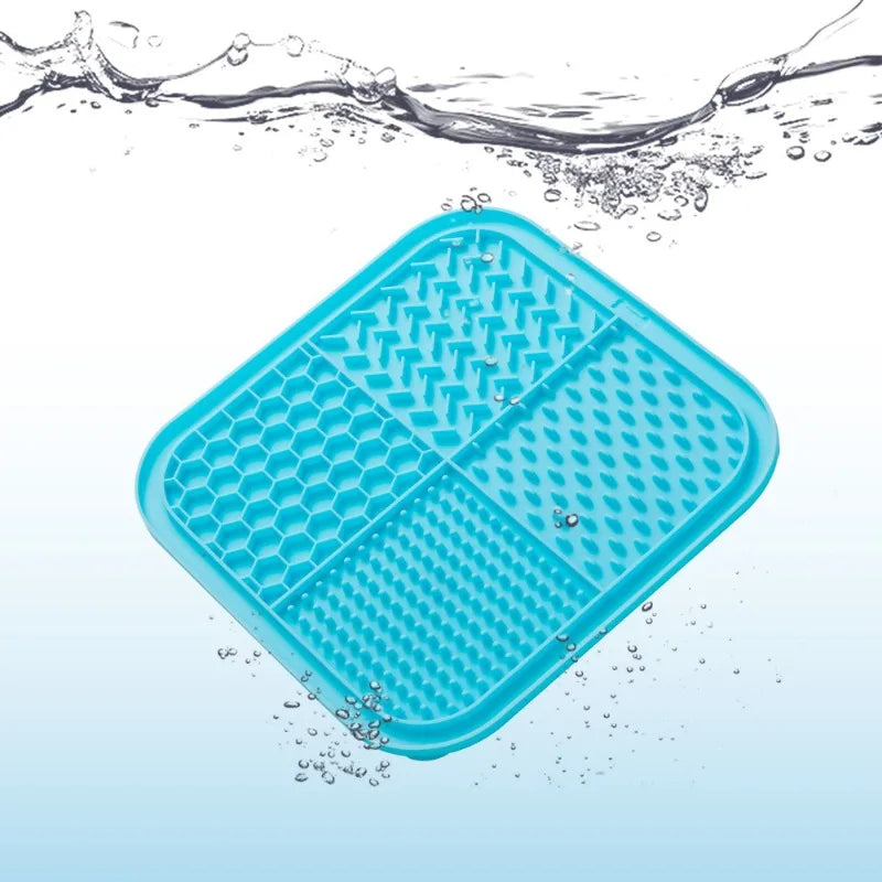 A bright blue silicone lick mat for pets floating in water.