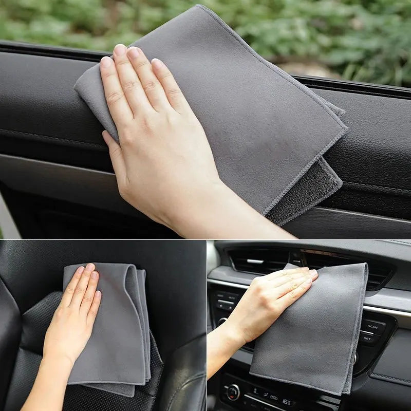 A hand is holding a gray ultra-soft coral fleece car drying towel on a car interior surface.
