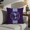 A purple decorative pillow featuring a white circular logo with a map of North and Central America inside.