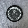 A black tactical patch featuring a skull design and the text DEATH VIC TO RY ARE REAL on a silver background.