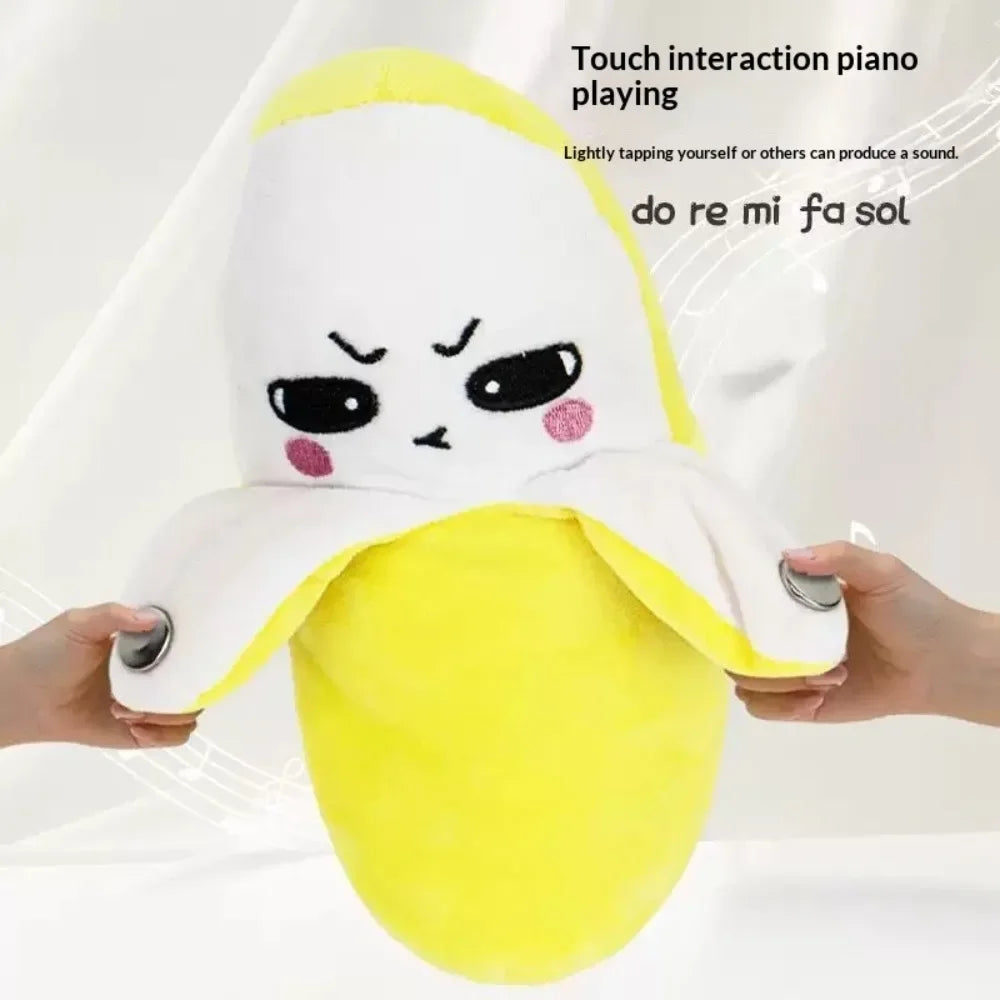 A yellow plush bear toy designed for touch interaction and piano playing, showing a cute face.