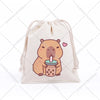 A beige drawstring storage bag featuring a cute, illustrated capybara holding a pink drink.