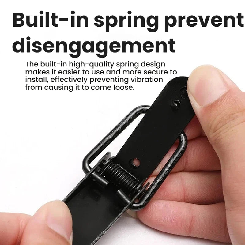 A hand is holding a black alloy hood pin lock kit, demonstrating its design.
