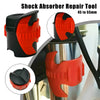 An orange and black shock absorber repair tool is shown being used on a motorcycle fork seal.