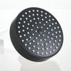 A matte black shower head with multiple small nozzles is shown on a white surface.