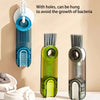 A set of three silicone cleaning brushes for cups and bottles, shown hanging on a wall.
