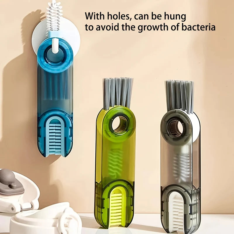 A set of three silicone cleaning brushes for cups and bottles, shown hanging on a wall.
