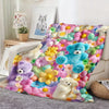 A colorful flannel throw blanket featuring various pastel-colored teddy bears and floral patterns.