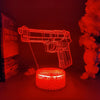 A glowing red silhouette of an old man and the sea gun-shaped night light against a dark background.