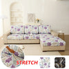 Floral elastic sofa cover showing a purple and green floral pattern on a beige sofa cushion.