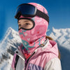 A young person wearing a pink floral balaclava mask and goggles in a snowy mountain landscape.