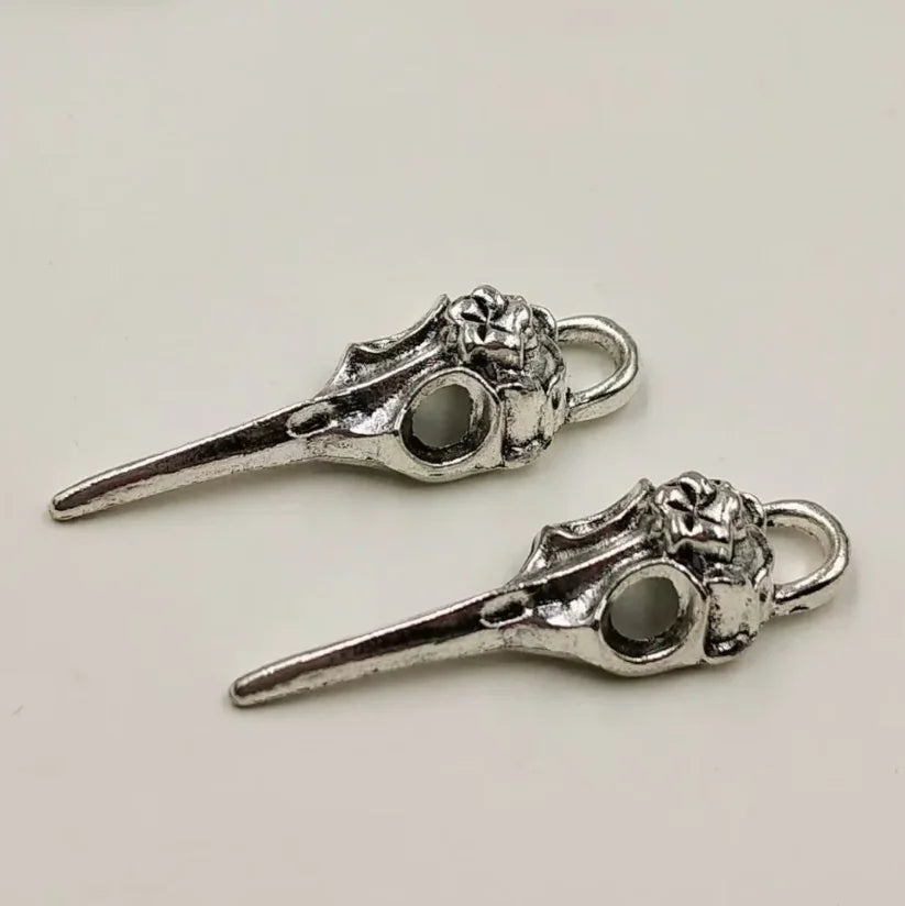 A set of five silver gothic skull and crow head charms for jewelry making
