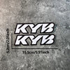 Black and white KYB motocross motorcycle fork stickers displayed against a gray textured background.