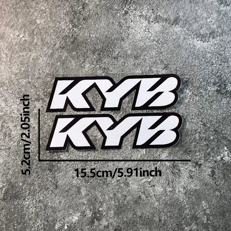 Black and white KYB motocross motorcycle fork stickers displayed against a gray textured background.