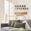 A light gray sofa is covered with a solid olive green non-slip fabric and features protective layers.