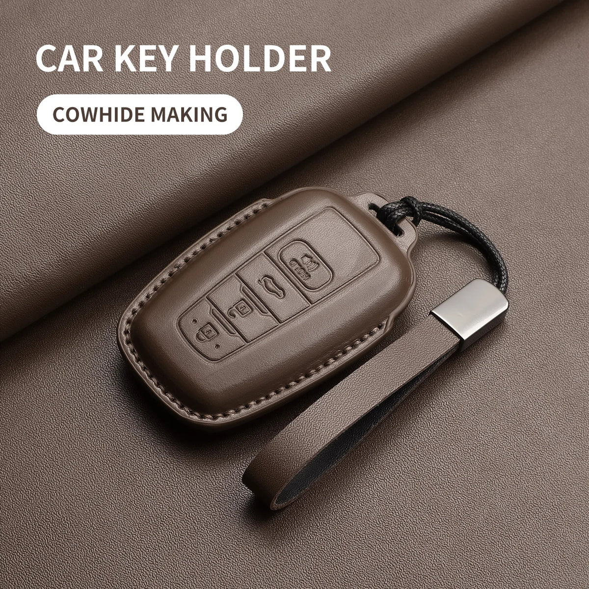 Brown genuine leather car key holder with a metal strap and leather cover shown on a dark background.