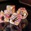 A close-up of a set of colorful resin dice featuring animal designs and glitter in various shapes and colors.