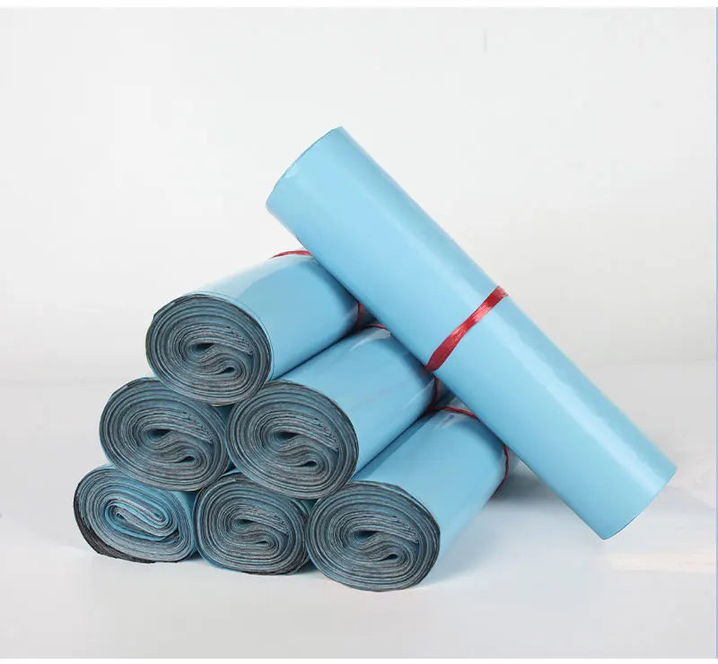 A roll of light blue heavy-duty waterproof poly mailer bags for shipping and storage.