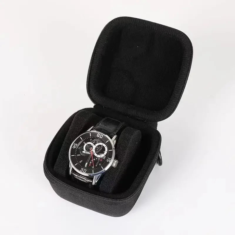 Black multi-slot watch travel organizer case with a comfort pillow and a wristwatch inside