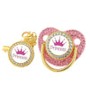 A set of pink crystal rhinestone pacifier chain clips with silicone nipples and gold clasps.