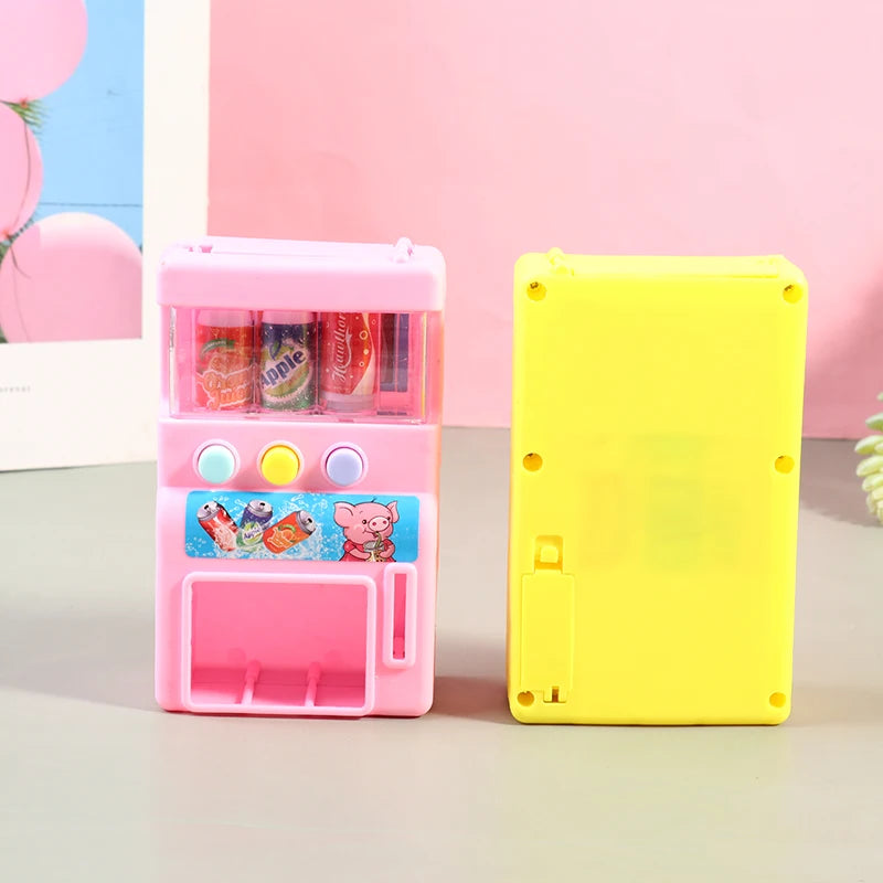 A pink interactive vending machine toy with coin slots and drink compartments sits next to a yellow version.