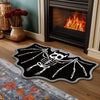 Black decorative rug featuring a white ghost and spider web design