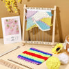 A wooden weaving loom kit with colorful yarn and a finished textile displayed against a beige background.