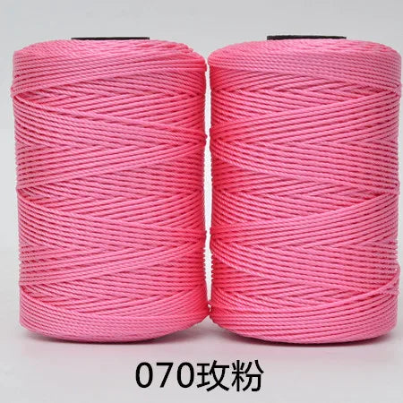 Two spools of pink 3-ply polyester knitting yarn for crochet and hand crafts