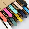A box filled with various colored soft silicone sport bands for an Apple Watch.