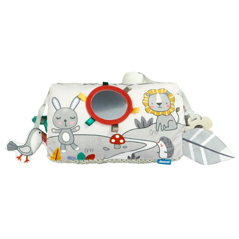 A soft, light-colored fabric pillow featuring cute animal designs and a circular opening for tummy time.