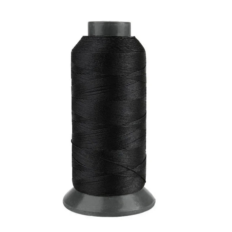 A spool of black heavy-duty nylon sewing thread for upholstery and denim.