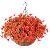 A vibrant arrangement of artificial orange and red morning glory flowers hanging from a black hook above a woven basket.