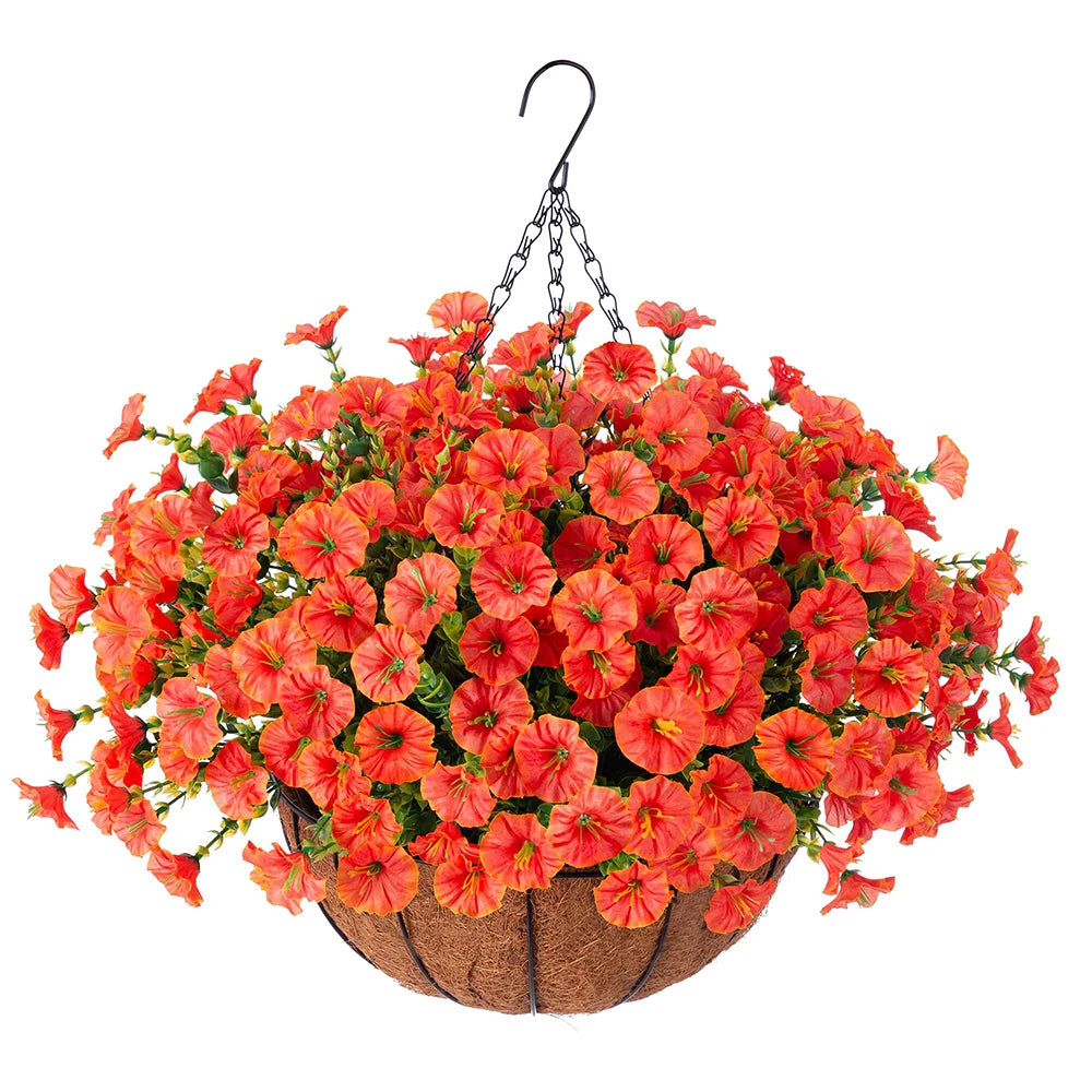A vibrant arrangement of artificial orange and red morning glory flowers hanging from a black hook above a woven basket.