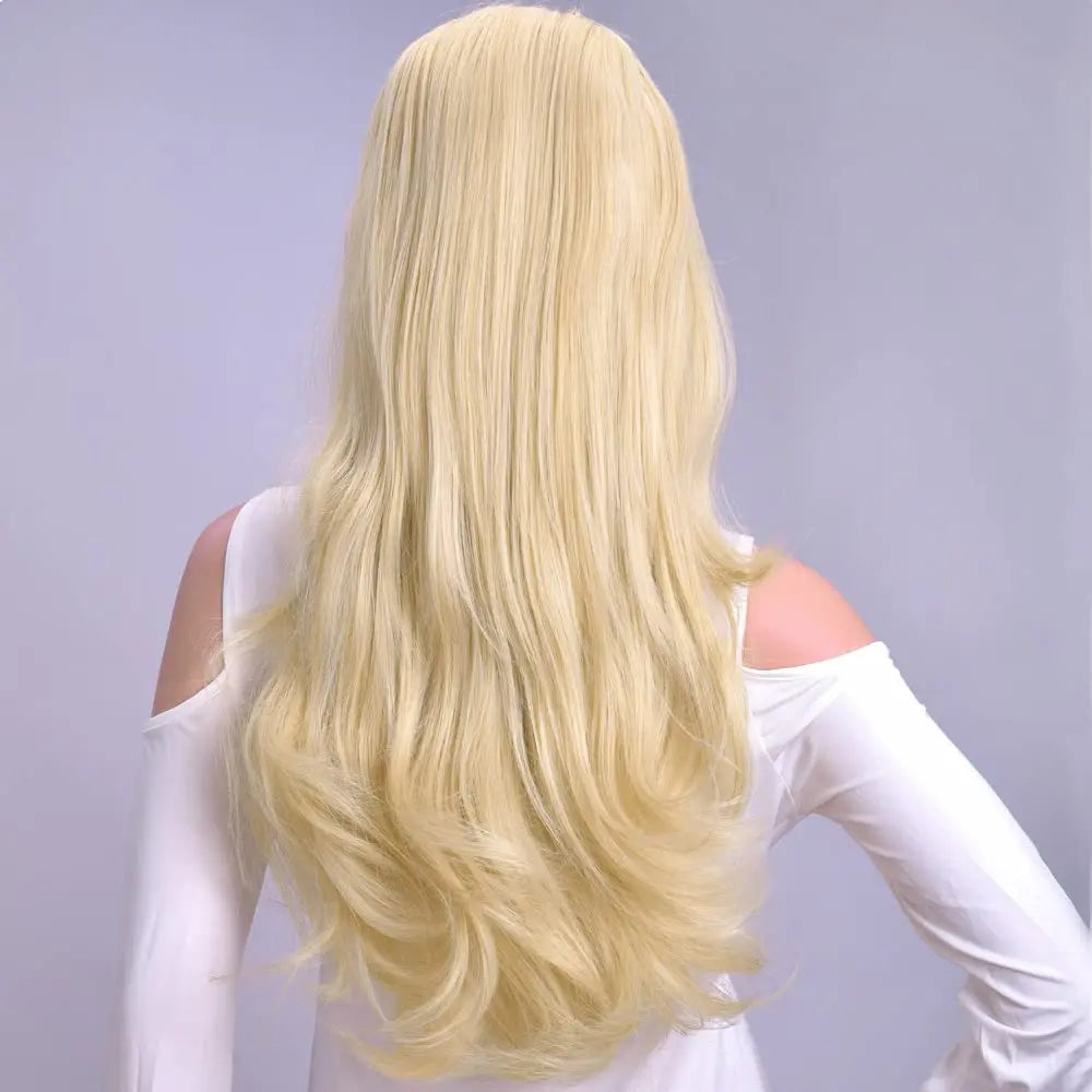 A long, blonde wavy half wig is shown from the back against a light gray background.