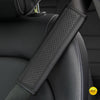 A close-up of a black PU leather embossed seat belt shoulder cushion on a vehicle seat.