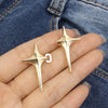 Gold Y2K star-shaped waist tightener clips for jeans shown on a hand against denim fabric